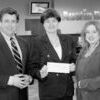 Jeff Austin III, Austin Bank vice-chairman presents $500 checks to Vickie Lotito, bank employee, for her volunteer work and Cynthia Kline, 2007 chairman of Relay for Life, Ms. Lotito's charity.