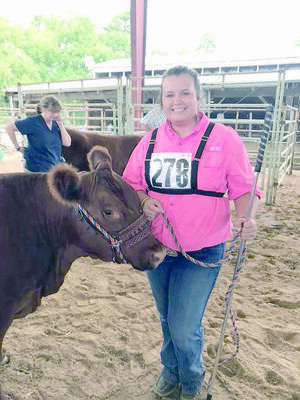 Courtesy Photo
Brooklyn Hooker of Jacksonville FFA received first place for her Red Angus heifer, Red Lazy MC Kuruba, during the livestock show held during the East Texas State Fair in Tyler.