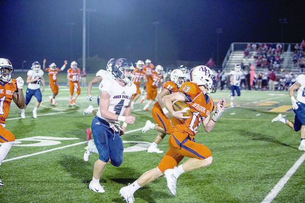 Courtesy Photo
Brook Hill Guard No. 13 Fisher Bass runs past No. 4 from John Paul II during Friday night’s game.