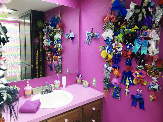 Photos by Cristin Parker
The Simmons’ girls get their own hot pink bathroom and all the hair bows they can stand.