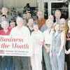 Business of the Month banner was presented by the Rusk Chamber of Commerce last week to Mike Crysup, owner of Knox Ray Men's Wear. Accepting the honor were Mr. Crysup and his wife, Sissy. The two are surrounded by friends and representatives of the city and chamber of commerce.