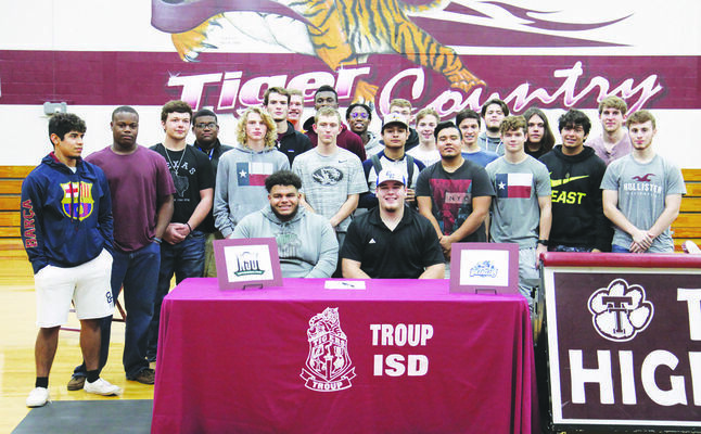 Courtesy Photo
Cade Jones and Malik Gilliam, pictured with their teammates, both sign their intent with the colleges of their choice last week.