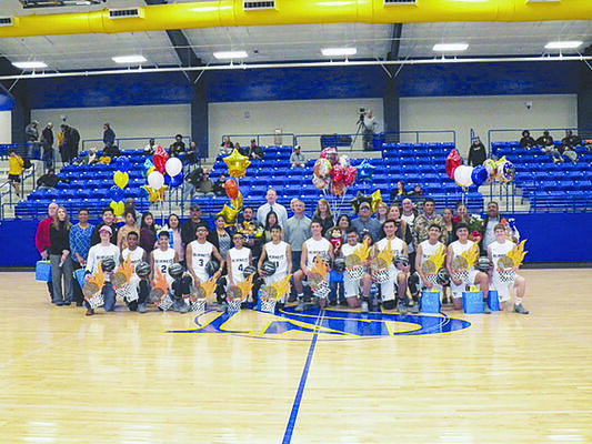 Photo by Michelle Dillon
New Summerfield recognized the seniors playing on the varsity basketball team Friday, Feb. 8, which resulted in a celebration of the entire squad. They are pictured here with family members. The team includes (from left) Carson Burns, Jayce Fry, Jose Nunez, Bryant Leon, Juan Hernandez, Luis Martinez, Collin Wilkerson, Elvis Mendoza, Julio Parra, Jose Leon, Alfredo Juarez Rojas and Dakota Stewart.