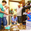 From left, Cherokee County Child &amp; Family Service Board President Nancy Washburn, board member Shirley Reese and drive organizers Diki and Jerry Parker get a peek at some of the many donated items collected during last month’s Christmas in July donation drive, to help stock the county’s Rainbow Room. Donations were delivered to the Rainbow Room on Aug. 9. Also pictured is Reese’s husband, Jim, who documented the delivery for the Rainbow Room.