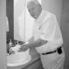 KOA's Phil Davis demonstrates the working faucet in the men's room at the Cherokee Civic Theatre. Previously, the sink in the mens' room could not be turned on during a performance due to noise made by the pipes. Mr. Davis, along with Walter Preble, paid for the parts to fix the plumbing, while inmates from the Texas Department of Criminal Justice supplied the labor.