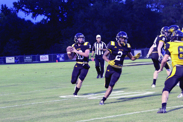 No. 10 Harmon West looking for an open receiver while No. 2 Vi'Dareous High blocks and offers coverage during Alto’s first home game on Friday, Sept. 7.