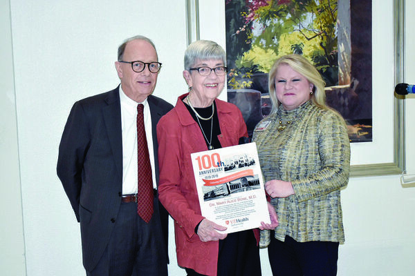 Photo by josie fox
Dr. Mary Alice Bone, center, shows off the commemorative keepsake UT Health presented her during the healthcare system’s 100th anniversary reception. Also picured are UT Health-Jacksonville CEO DeLeigh Haley, right, and UT Health-Jacksonville Board of Trustees Chair Joe Angle.