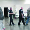 Photo by Cristin Parker
Rusk Police Chief Joe Williams and Sgt. Nathan Acker escort George Stover back to his seat during the Rusk meeting on Dec. 27.