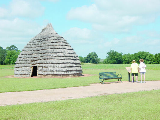 Photo by Cristin Parker
Visitors to the Caddo Mounds State Historic Site read up on the historically accurate replica of the traditional grass house the ancient Caddo people would have built while living at the site. The Site recently won the Vernacular Architecture Forum’s 2018 Paul E. Buchannan Award, recognizing the house for its contribution to the study and preservation of vernacular architecture and the cultural landscape.
