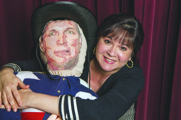 Photo by Heather Beck
Playwright and director Minette Bryant poses with the marionette Garth Brooks doll she made for A.M. WWJG. The doll, which will be used in the production, will be raffled off to one lucky theater patron following the final performance of the play. Tickets are now available at the box office for the production.