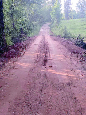 The same county road, after Precinct 1 road crews replaced the culvert and repaired the road surface over the last few weeks.
