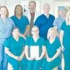 The “Bo Green Team” at ETMC Jacksonville collectively received a DAISY Team Award for their efforts in caring for toddler Bo Green after a drowning accident last Christmas Eve. In front are RNs Sandy Lara, Mary Burgess and Misty Wilburn. In back are RNs Monie Johnson, Janine Cole, Dr. Mark Shaw, RT Stelvin Cole, RN Alvie Vickers and LVN Amanda Parker.