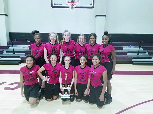 Displaying the hardware brought home from the Whitehouse Basketball Tournament Dec. 8 are team members (top row) Kierra Milton, McKaila Davis, Kennzie Norton, Andi Yount, Breanna Humphries, Jada Nelson, (front row) Jaylenne Hill, Mia Lopez, Nicole Burkhalter, Kelsey Woodard and Janiece Swindell.