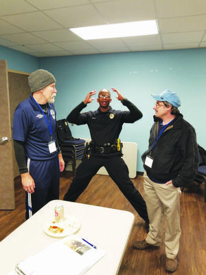 Photo by Josie Fox
Rusk Officer Ronald Wherry demonstrates how to do a body search to members Steve Goode, left, and Ben Mims.