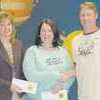 Rusk Elementary School teachers who received bonuses for perfect attendance were Sarah Massingill (left) and Darla Moore. The checks were presented by Rusk ISD Boardmember Rodney Hugghins. Every year, Rusk ISD rewards teachers with bonuses which are enhanced by perfect attendance, tenure and school performance, among other considerations. Rusk Elementary School bonus checks were also enhanced because the school earned the "Recognized" accreditation designation by the Texas Education Agency.