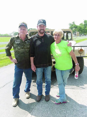 Courtesy Photo
Tom Townsend, left, and his wife Jan, right, recently worked with Chuck Norris and the History Channel by providing their Humvee for the channel’s show ‘Epic Guide to Military Vehicles’.