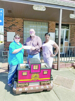 Photo by Josie Fox
Judy Faye Garner, far left, accepts a check on behalf of the Cherokee Civic Theatre in Rusk on Tuesday, March 26. Presenting the check is City Manager Jim Dunaway and City Secretary Rosalyn Brown.
