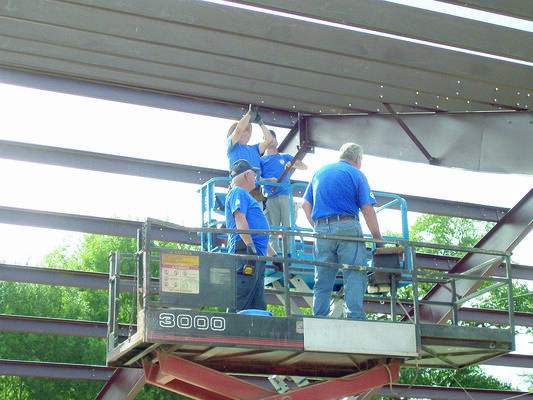 Volunteers with the Texas Mission Builders work on getting the frame up for Memorial Missionary Baptist Church's new building.
Photo by Cristin Parker