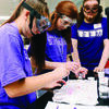 Students conduct an experiment simulating how chemists determine toxicity while Paul Rogers, Stephen F. Austin State University junior computer science major from Wells, assists.
