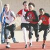 Rusk's Caleb McNair hands off the baton to Jonathan Long while Connor Ellis takes the baton from Nathaniel Wallace.