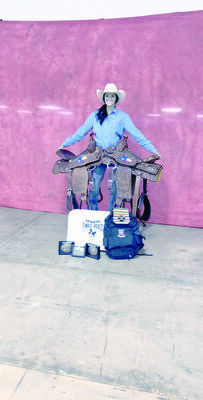 Davis shows off her prizes after earning the pole bending championship and All Around Cowgirl in the Texas High School Rodeo Association State Finals.