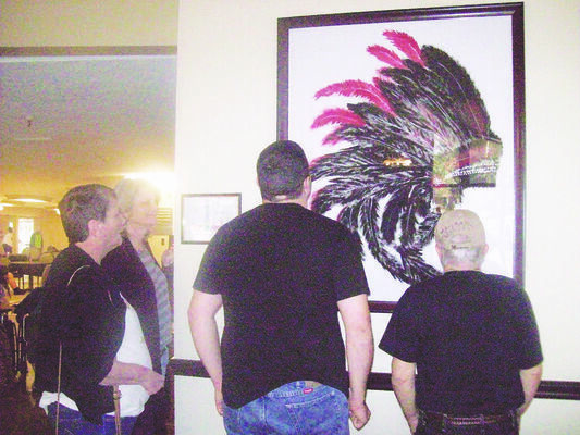 Photo by Cristin Parker
Cherokee Trails Rehab and Healthcare Center residents enjoy a painting recently presented to the facility. The subject of the painting, done by a local artist, reflects the Cherokee people’s heritage and honors the Rusk Eagles in its color scheme.
