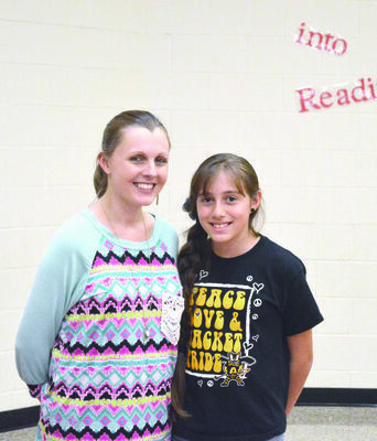 Alto Elementary student Angelina Lindsey, a 10-year-old fourth grader, placed first with her entry in the conservation poster contest sponsored by the Cherokee County Soil &amp; Water Conservation District. She is pictured with teacher Amanda Low.
