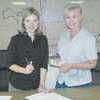 Mayor Angela Raiborn k signs a lease agreement allowing the Rusk Chamber of Commerce to operate the Whitehead Heritage Park. Penny Reynolds, chamber president, offers $1 as the annual lease money. PHOTOS: CONNIE BROWN