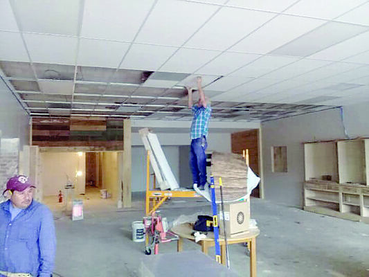 Courtesy Photo
A crewman with Clint Glaze Construction Company installs the drop ceiling in the Stella Hill Memorial Library in Alto.
