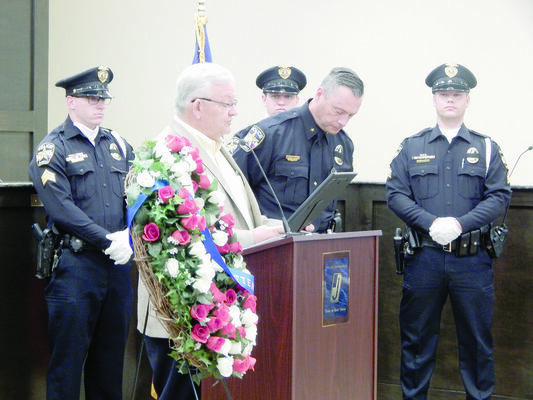 Photo by Josie Fox
Jacksonville Mayor Randy Gorham, front, left, presents Jacksonville Police Chief Andrew Hawkes, front, right, with the Peace Officers Memorial Day and National Police Week proclamation during a ceremony held Wednesday, May 15 at Jacksonville City Hall.
