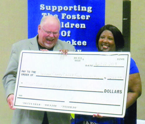 CCCFWB Chair Bill Avera accepts the donation presented by Women With Purpose organizer Regina Brown.