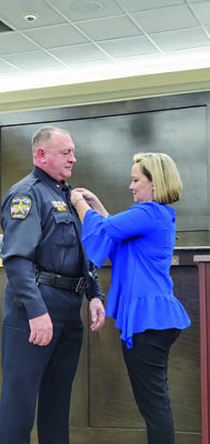 Photo by Josie Fox
Amy Williams, right, pins his new badge on her husband, JPD’s new Chief Joe Williams, left.