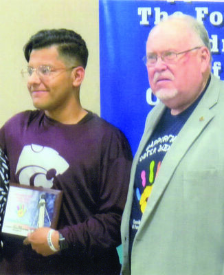 CCCFWB Chair Bill Avera, right, presents the Outstanding Youth of the Year to recipient Armando Gonzalez during the Board’s annual appreciation banquet.