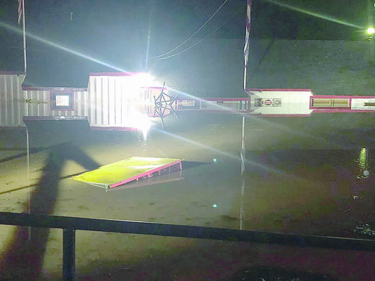Flood waters submerge Harry’s Building Material in Rusk Saturday night, when strong storms swept through the county.