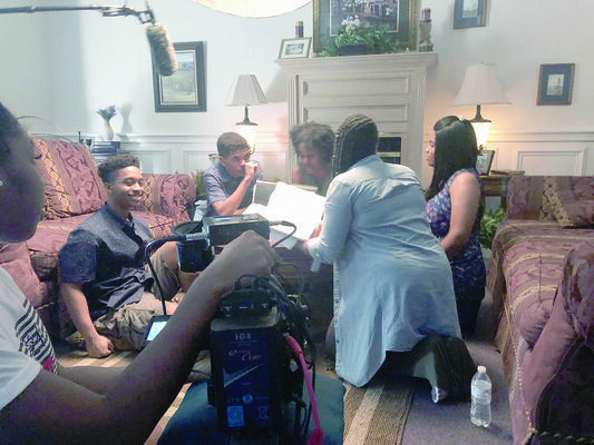 Courtesy photo
Alto resident Shanelle Gaddis, pictured far right, with cast mates and crew of the short film ‘Black Bones,’ discuss the nuances of the movie’s script during the two-day filming of the movie in July at Wiley College in Marshall.