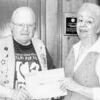 Billy Watson presents Doris Cook with her prizes from a raffle to benefit the Relay for Life. She won four Texas State Railroad tickets; breakfast for two at the Ironhorse Mercantile; lunch for two at the Legacy of Harvey Collins; dinner for two at the All Star Barbecue and $50 cash. The total package amounted to approximately $400.