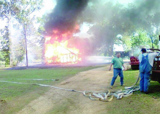 Courtesy Photo
Gallatin Volunteer Fire Department members prepare to attack a house fire in Cherokee County in 2011.
