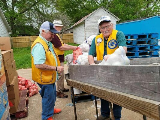 Members of the Rusk Lions Club provide muscle during a recent food distribution day at the Good Samaritan Food Pantry. The club recently received a $2,400 grant that helped pay for the April 7 food cost completely.

Courtesy photo