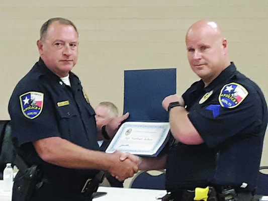 Photo by Cristin Parker
RPD Chief Joe Williams, left, presents the Life Saving award to Sgt. Nathan Acker during a recent council meeting, for his bravery and heroism.