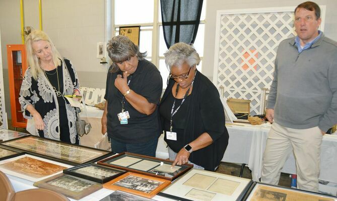RHS employees and guests enjoy the historical exhibits that were on display at the luncheon.